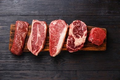 Variety of Raw Cow (beef) meat steaks Machete, Blade on bone, Striploin, Rib eye, Tenderloin fillet mignon